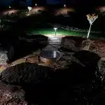 a stone walkway with lights at night