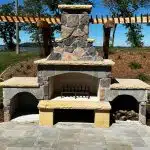 a stone outdoor fireplace with a stone structure