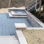 a pool with steps leading to a building
