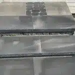 a close up of a grey tile