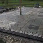 a pole on a stone patio
