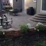a patio with a round staircase and chairs