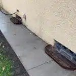 a concrete sidewalk next to a wall