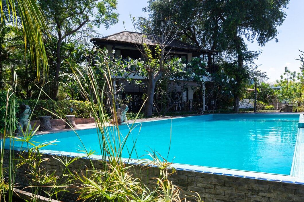 a pool with trees and plants around it