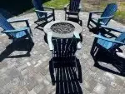 a group of chairs around a fire pit