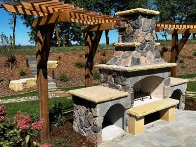 a stone fireplace with a pergola