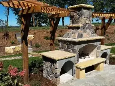 a stone fireplace with a wood pergola